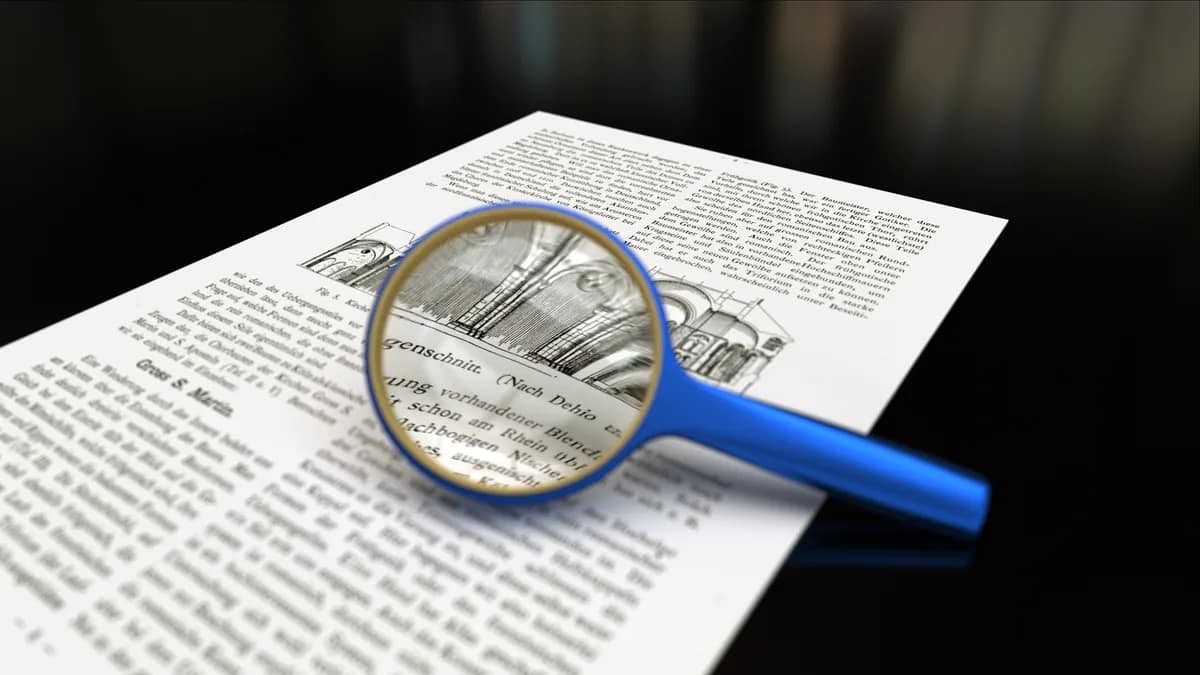 Illustration of a document with a faint hidden pattern in its text under a magnifying glass