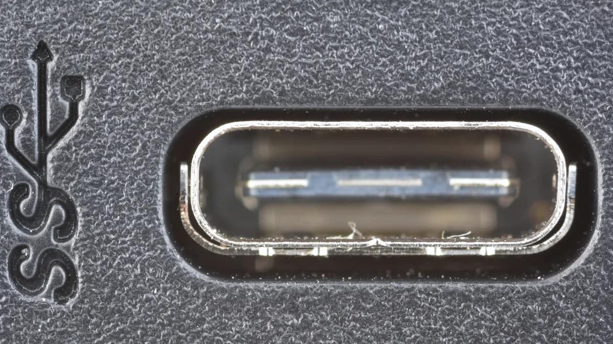 Close-up of a laptop's USB-C ports on the side of an aluminum body