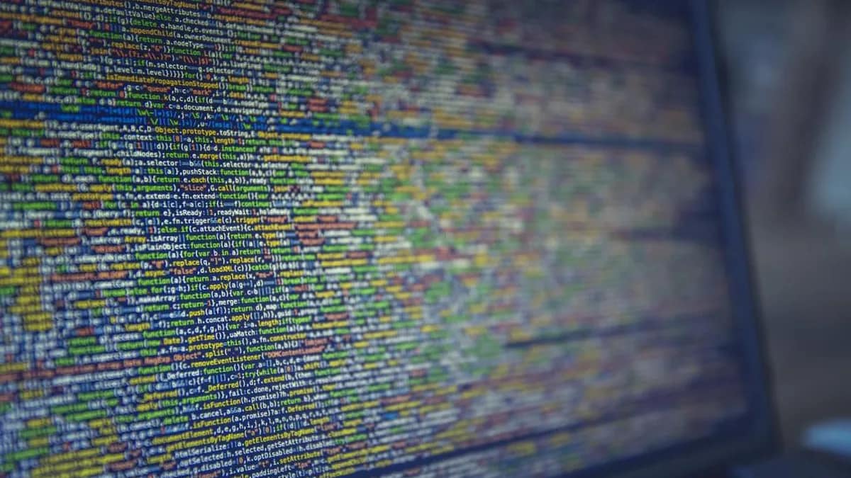 Developer at a laptop testing AI models with code on screen
