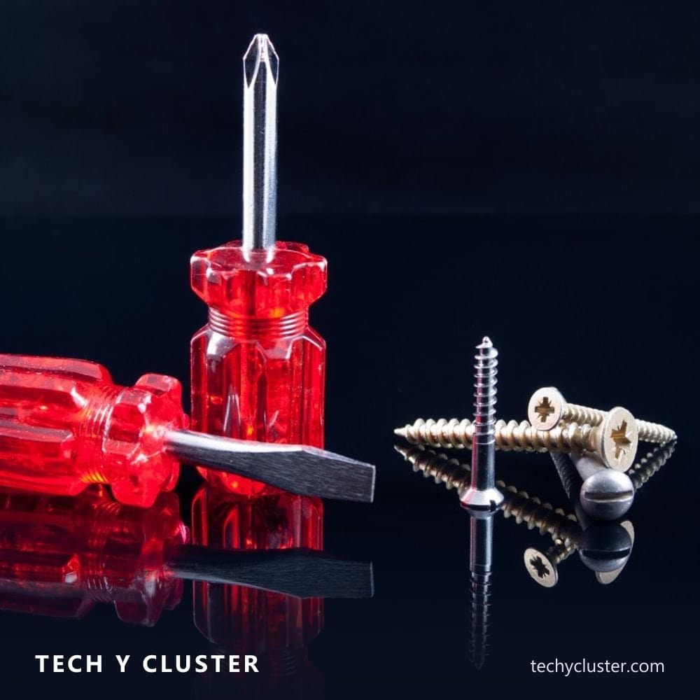 Screwdrivers and screws on a dark surface