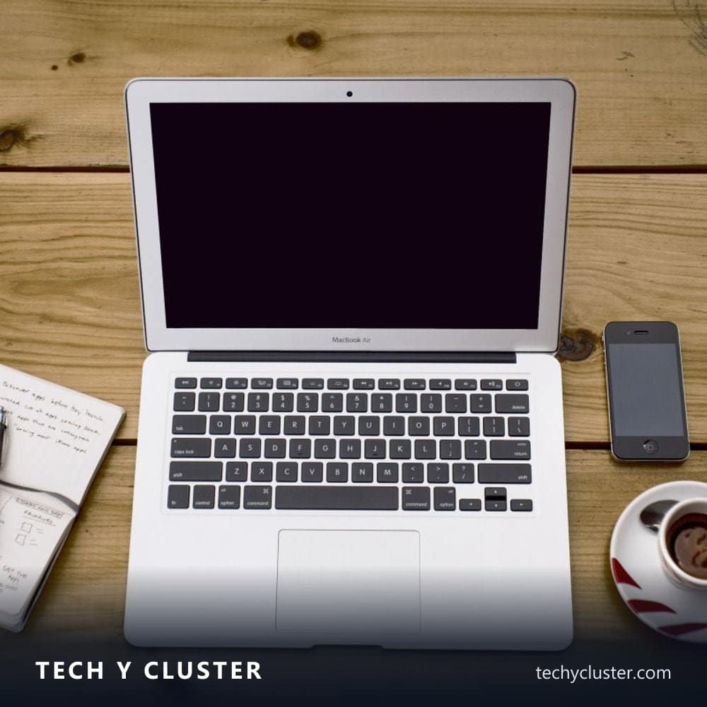 Laptop, smartphone and notebook on a wooden table
