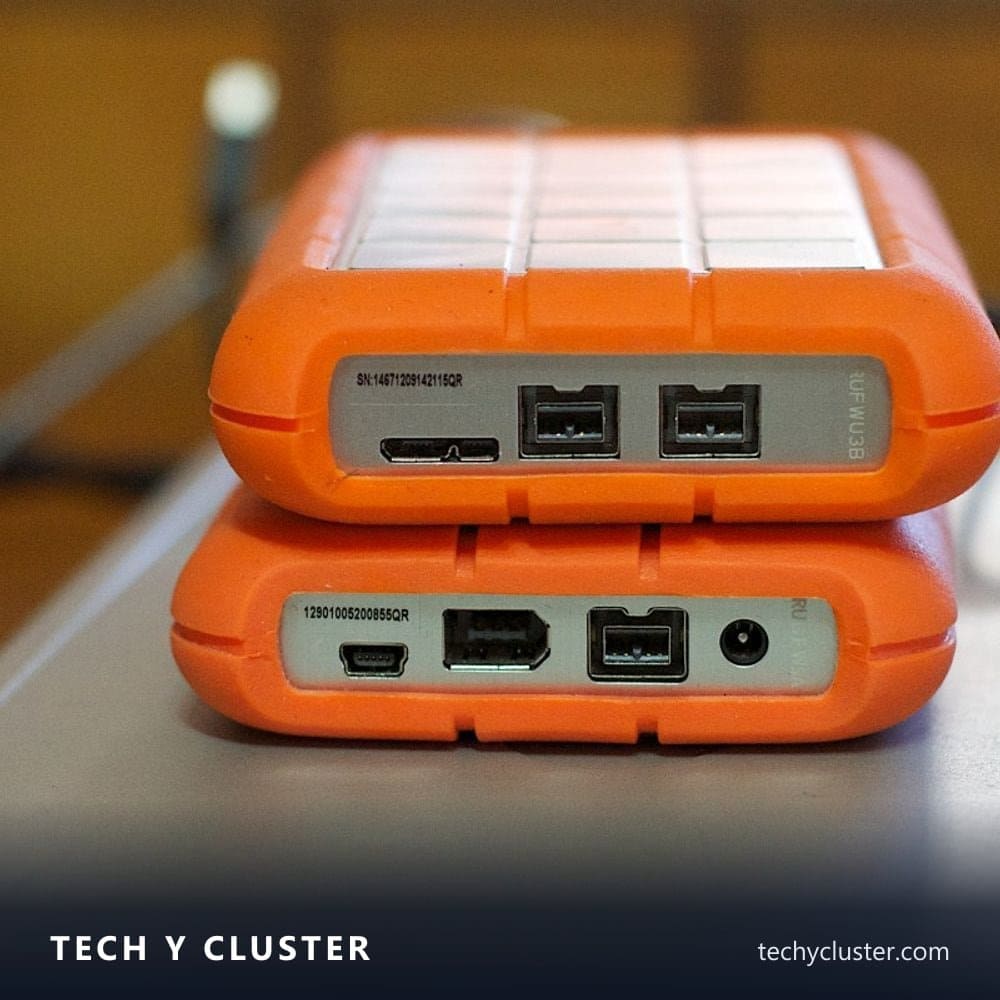 Two portable external hard drives stacked on a desk