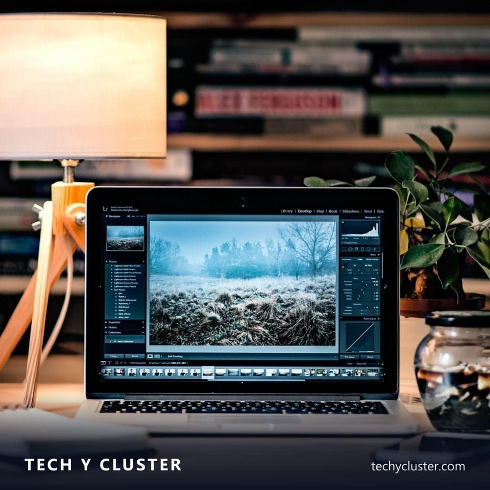 Laptop on a desk showing photo and video editing software