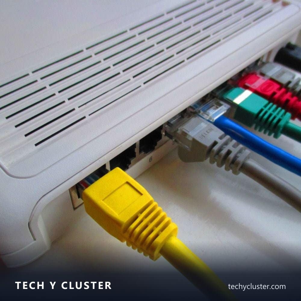 Network cables plugged into the back of a white router