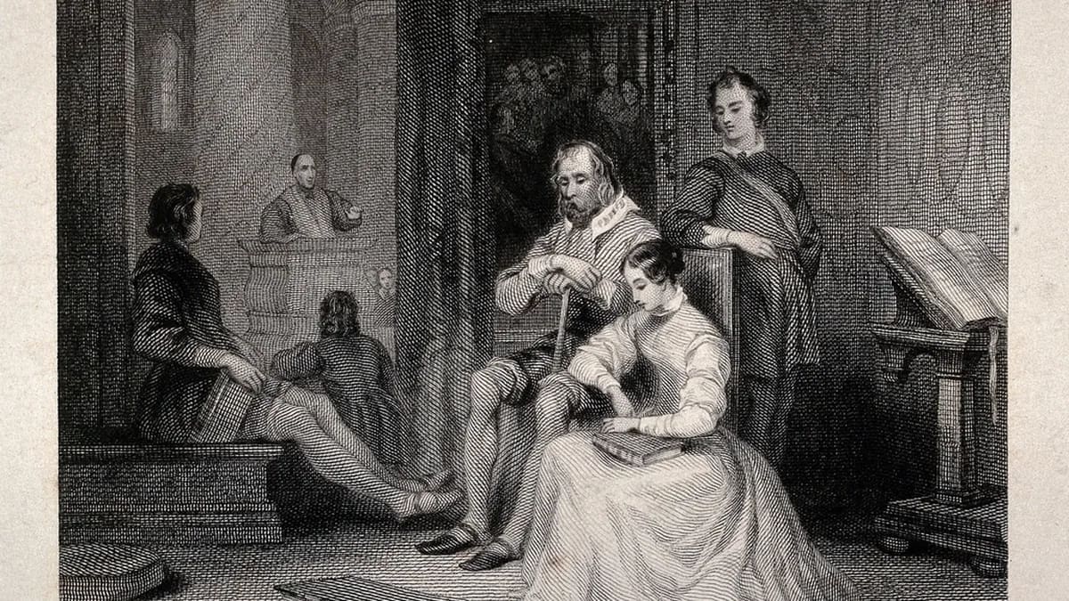 Family members sharing headphones and a phone while listening to music at home